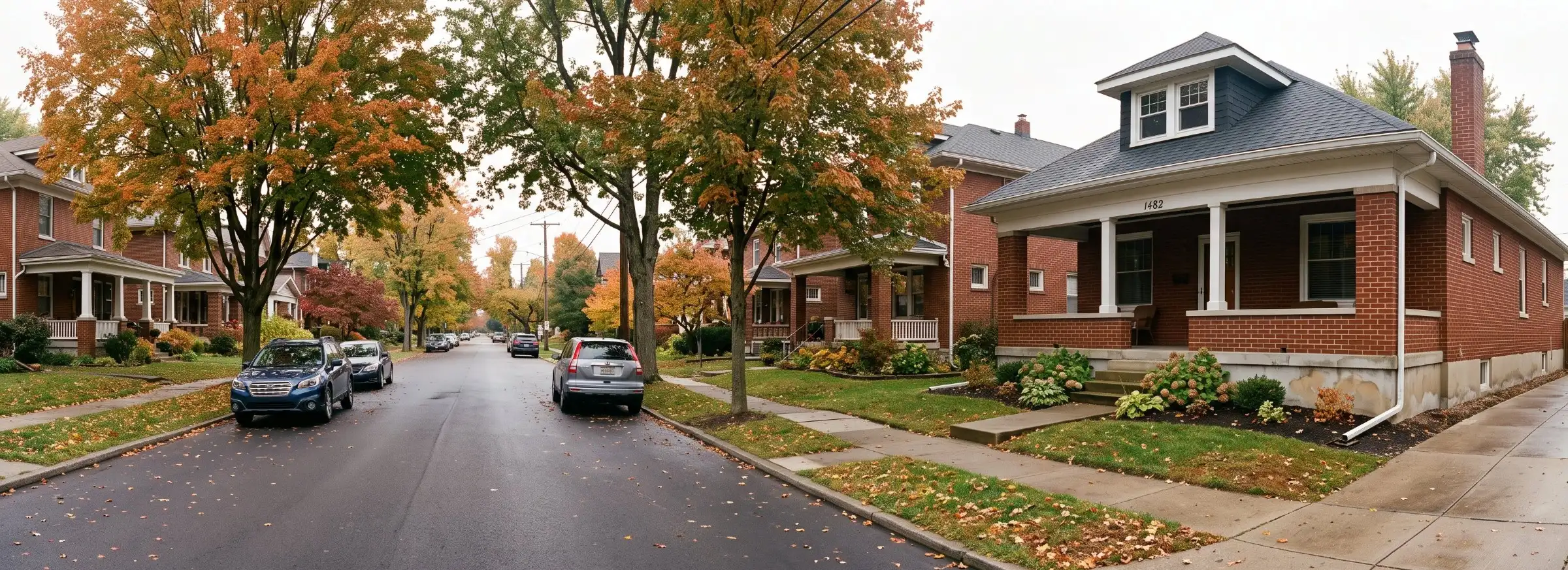 Brick bungalow with a covered front porch on a tree-lined residential street in Columbus, Ohio
